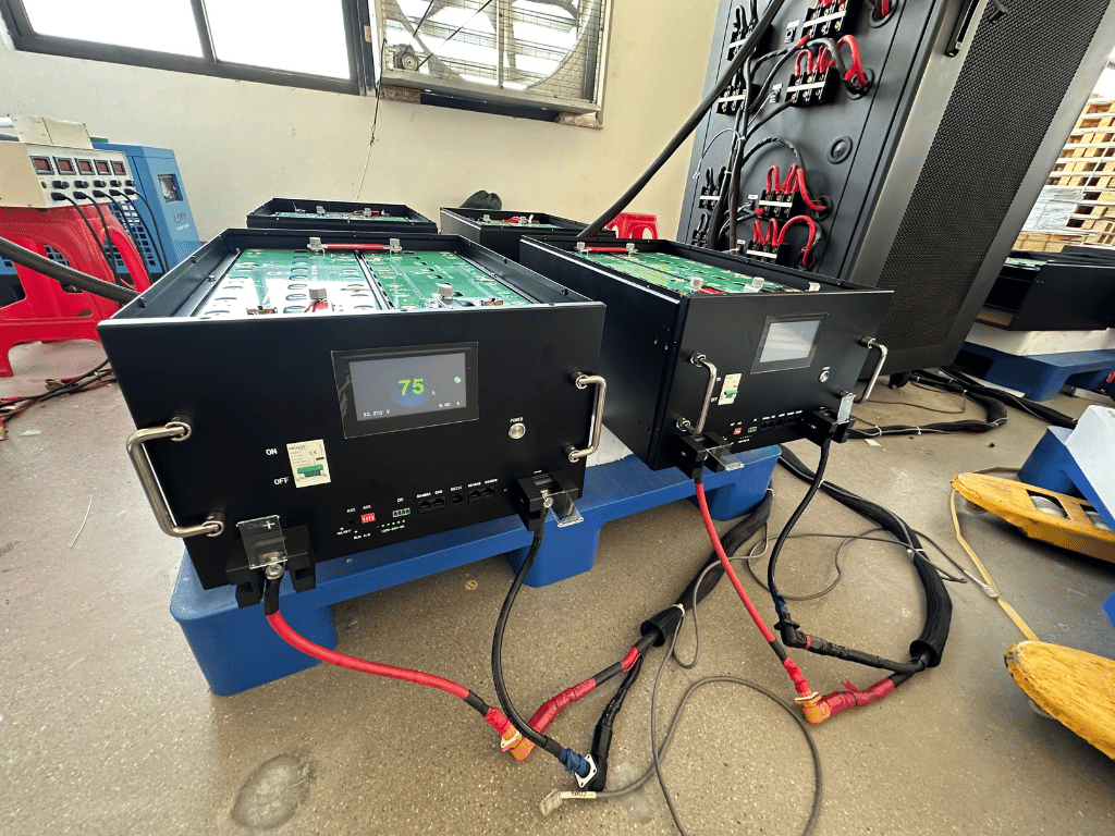 Rakour LiFePO4 high voltage rack battery systems installed in factory with wiring connections, compliant with CE, UN38.3, and IEC62619 safety standards